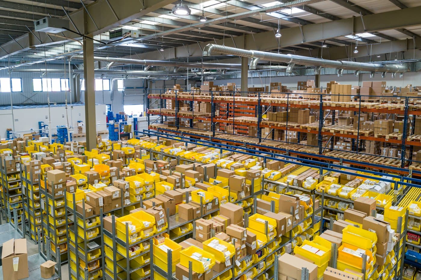 Fulfillment center aisles stacked with yellow inventory bins